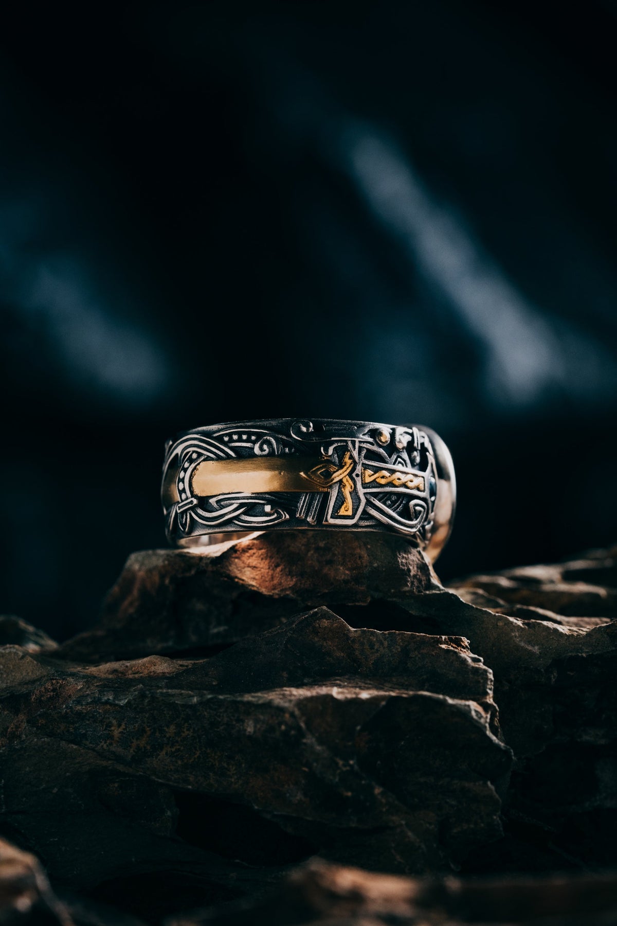Son of the Forest signet ring worn on a man's hand, sterling silver with a fire-gilded Tree of Life