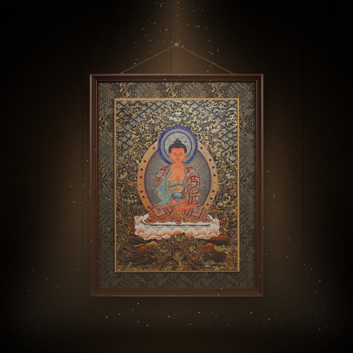Framed black and gold Amitabha thangka hanging in a room under warm light