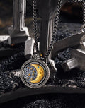 Three-quarter view of the reversible pendant, gold catching the light inside its Celtic plaited silver ring
