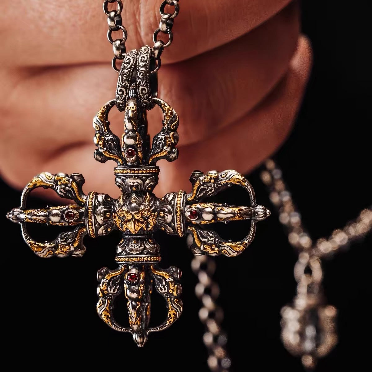 Fire-gilded garuda vishvavajra pendant laid flat, gold following every lotus petal and flame scroll