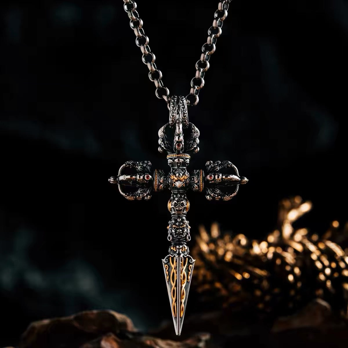 24K fire-gilded phurba pendant hanging on a silver chain, crossed vajra crown set with natural garnets