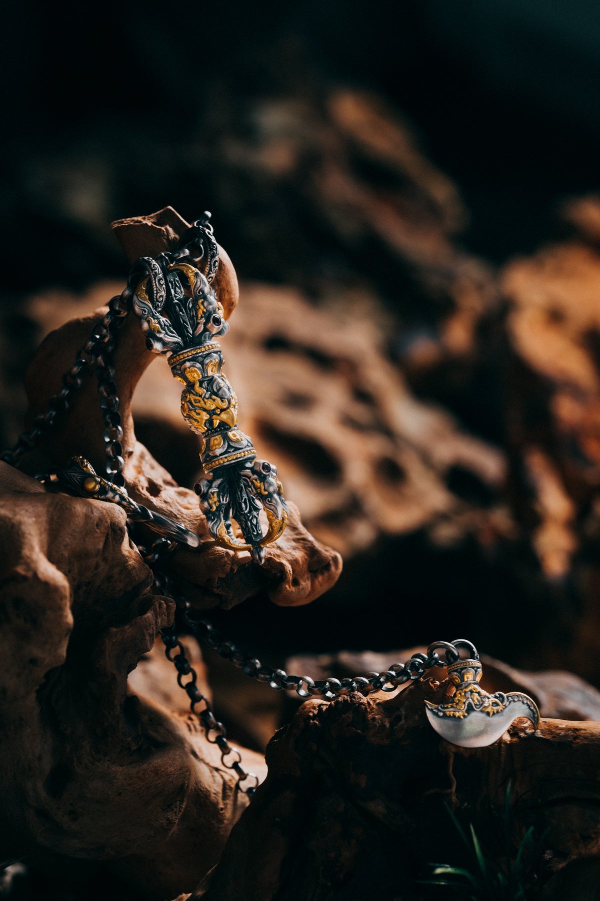 Three-quarter view of the fire-gilded garuda vajra, natural garnets set at the prong roots
