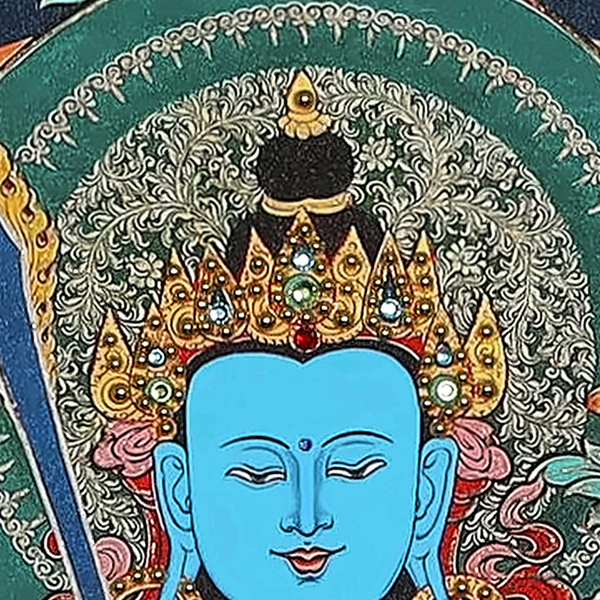 Akashagarbha thangka detail: blue face under a crown set with crystals