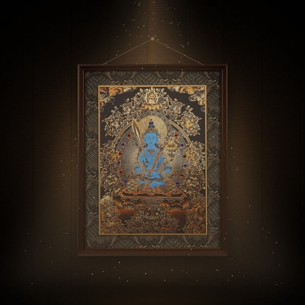 Akashagarbha black and gold thangka hanging in a room under warm light