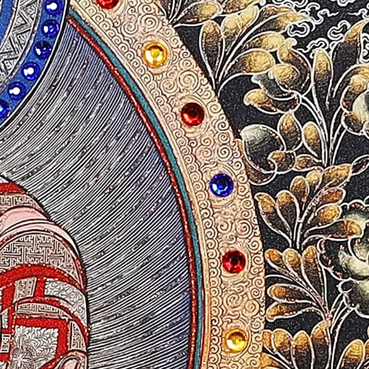 Amitabha thangka detail: red, yellow and blue crystals set along the gold mandorla