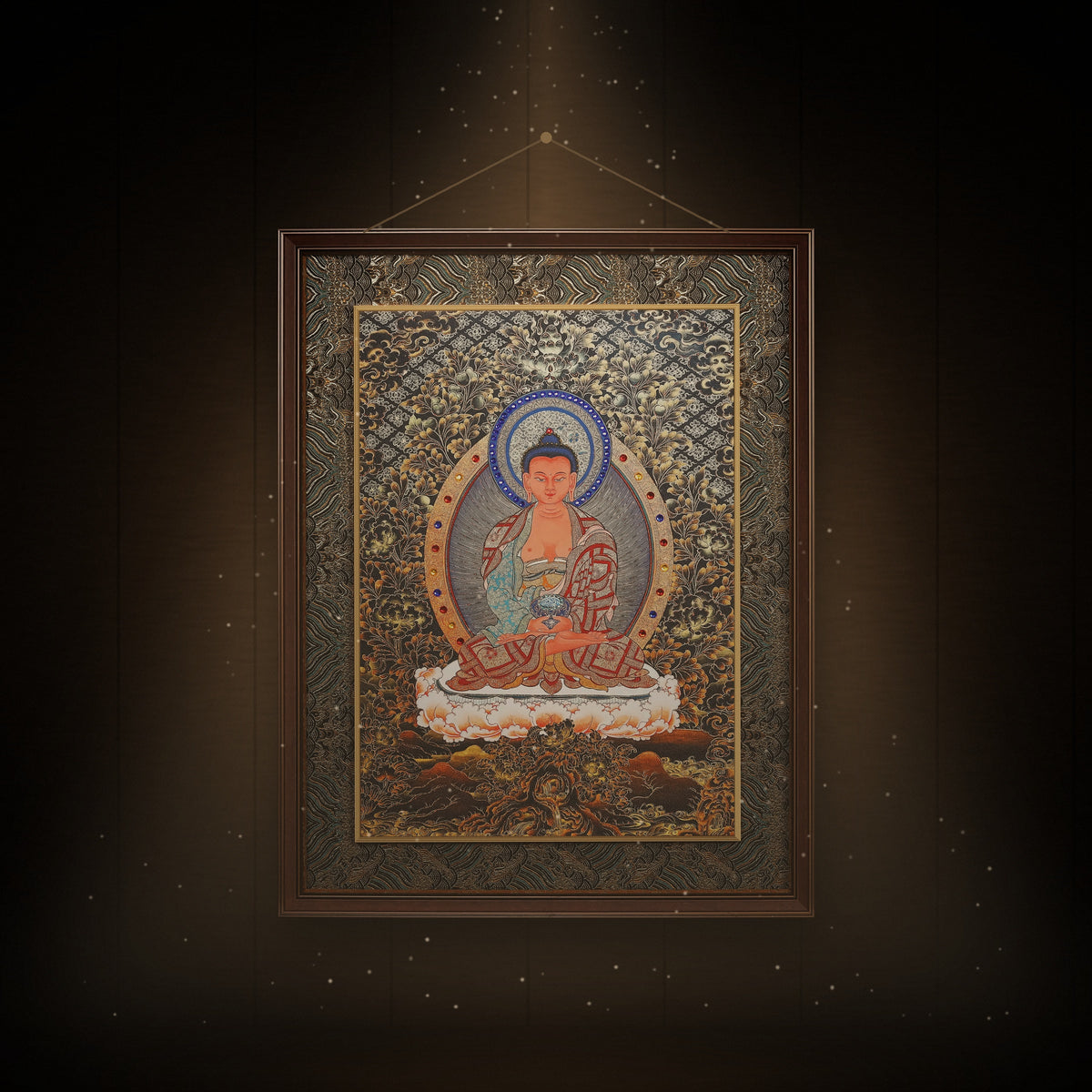 Amitabha black and gold thangka hanging in a room under warm light