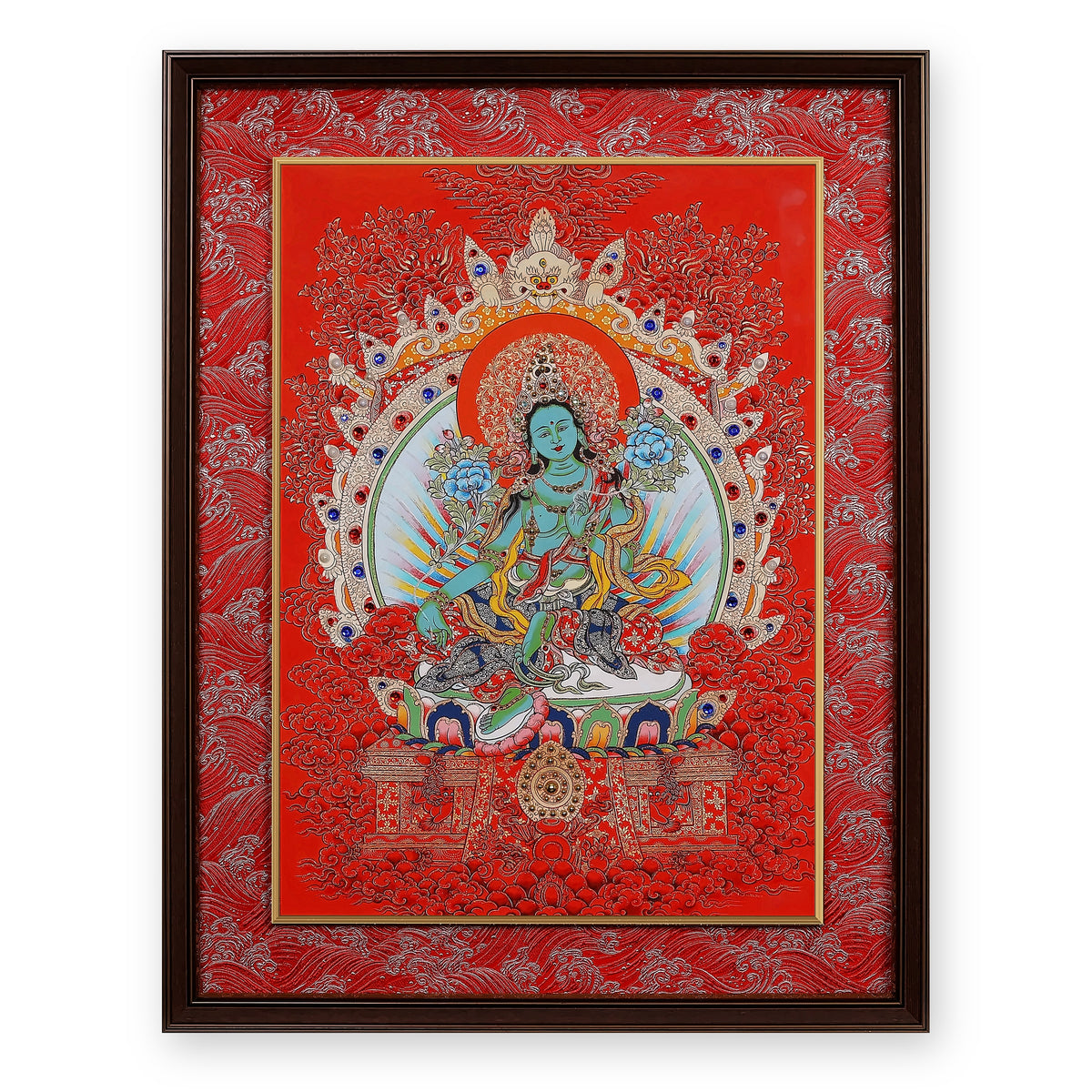 Green Tara thangka on a red ground, framed in Crimson Cloud silk brocade, on a white background