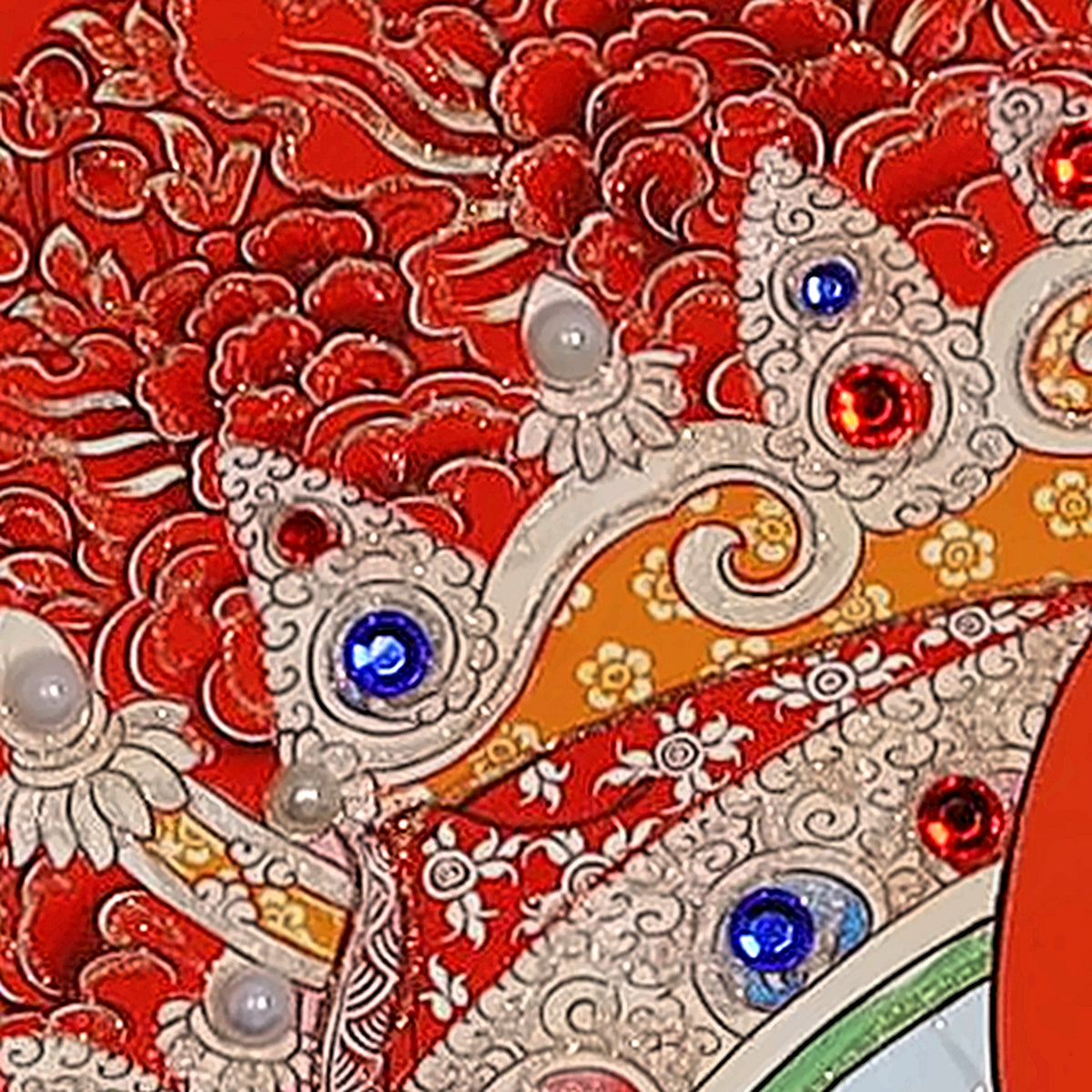 Green Tara thangka detail: red and blue glass crystals set by hand along the arch