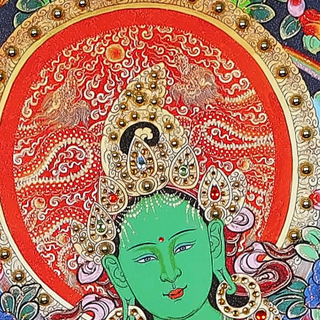 Green Tara thangka detail: green face under a jewelled crown and red halo