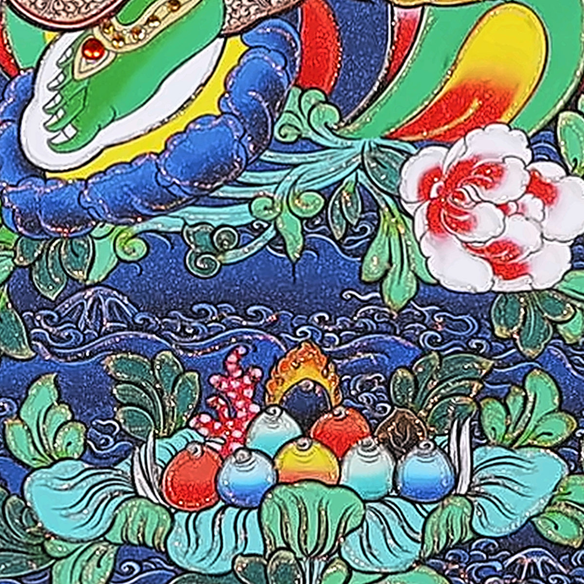 Green Tara thangka detail: jewel offering on a lotus below