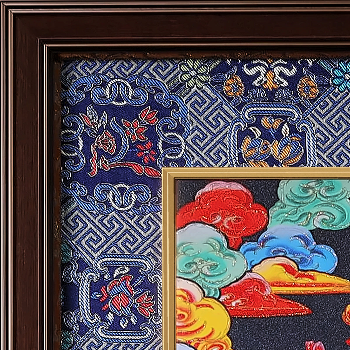 Green Tara thangka detail: corner of the blue silk brocade frame-within-a-frame