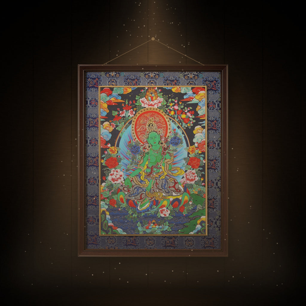 Green Tara night-blue thangka hanging in a room under warm light