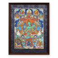 Green Tara thangka with the Five Buddhas above and three protectors below, framed in Night Sky silk brocade, on a white background
