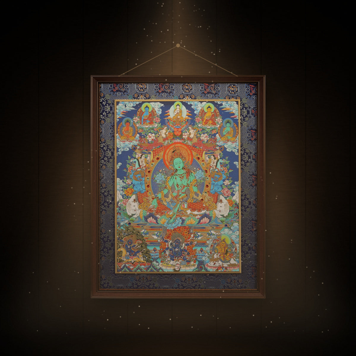 Green Tara with the Five Buddhas thangka hanging in a room under warm light