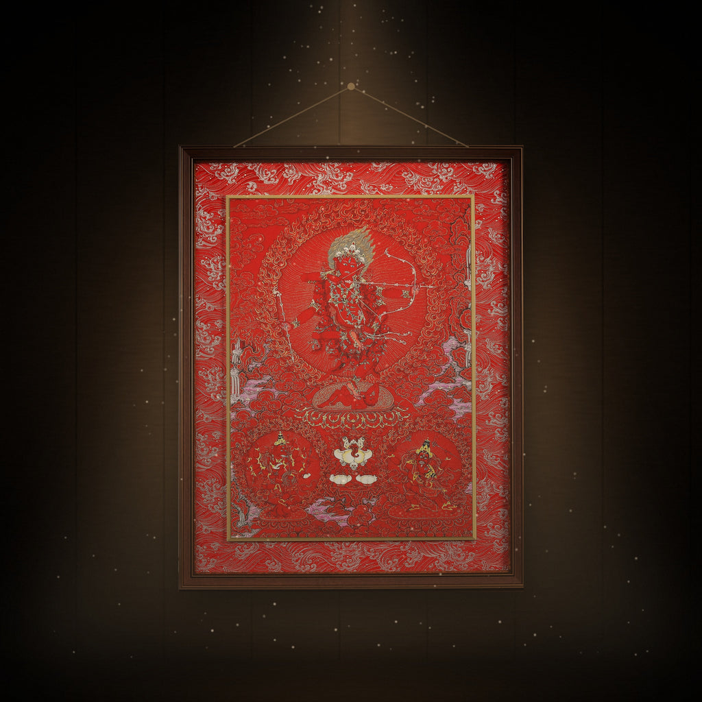 Kurukulla red thangka hanging in a room under warm light
