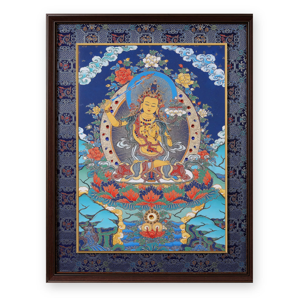 Manjushri thangka with flaming sword on a night-blue ground, framed in Night Sky silk brocade, on a white background