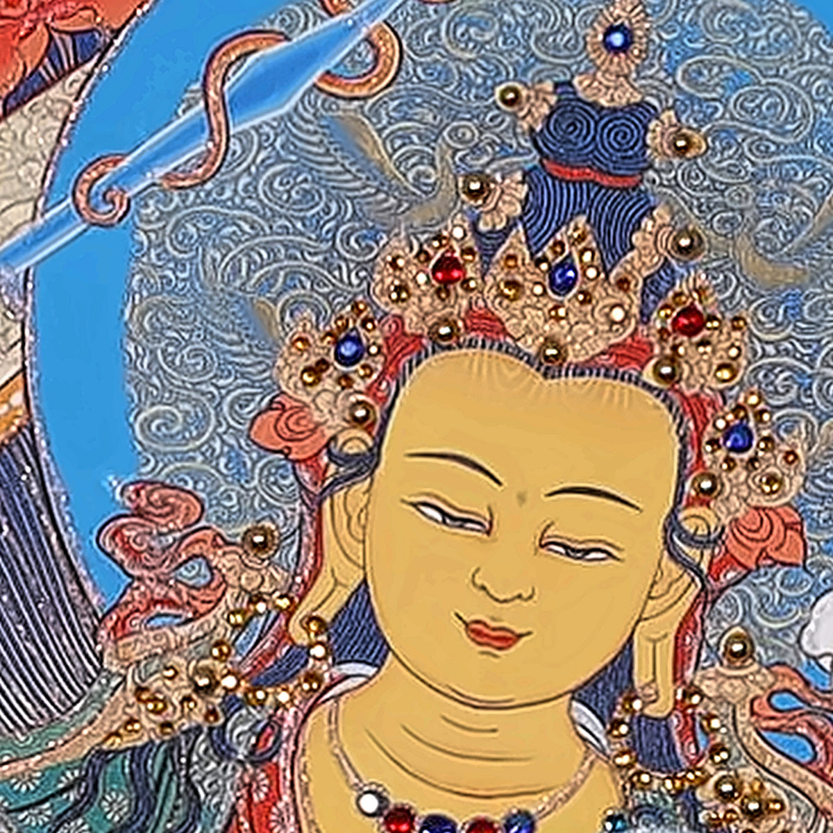 Manjushri thangka detail: young face and crown set with crystals
