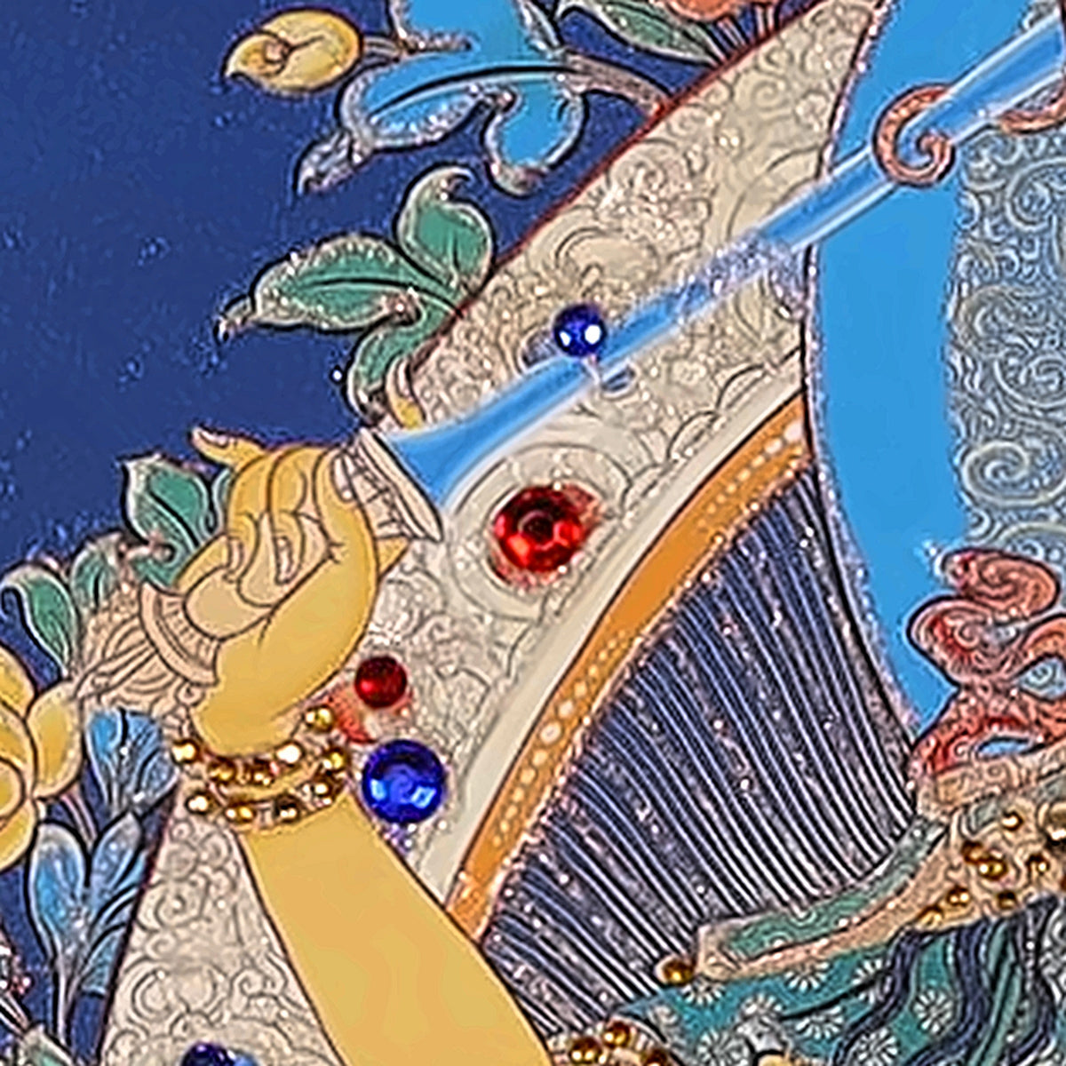Manjushri thangka detail: right hand raising the flaming sword of wisdom