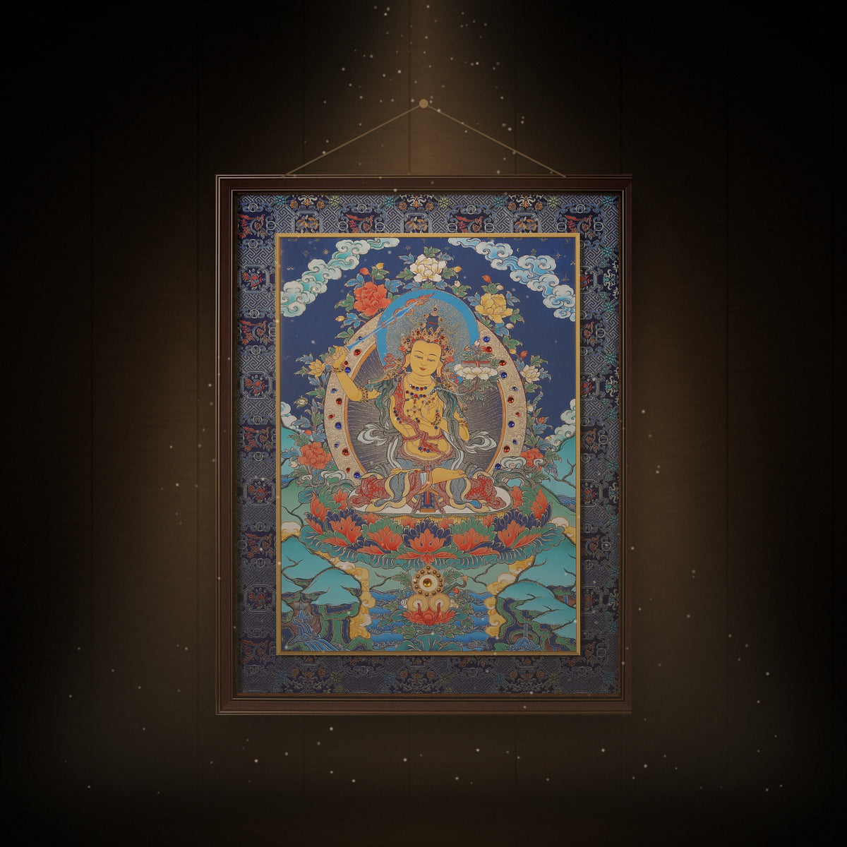 Manjushri thangka hanging in a room under warm light