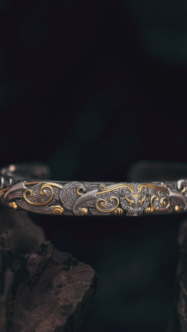 Taotie double-body bangle turning in the light, bronze-vessel beast mask in fire-gilded sterling silver