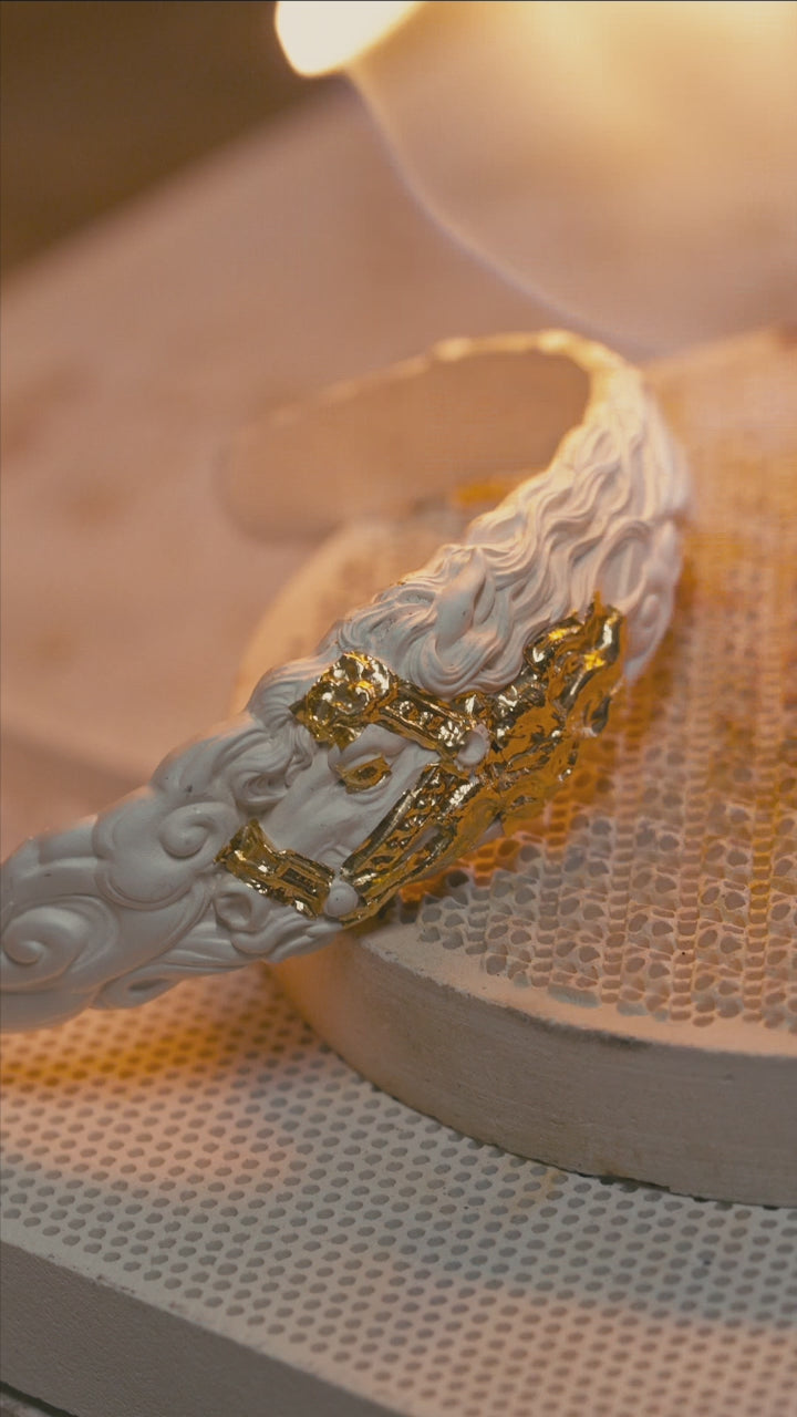 Wind horse cuff bangle turning in the light, gold swallow sweeping ahead of the horse over oxidised sterling silver