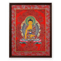 Shakyamuni Buddha thangka on a red ground, framed in Crimson Cloud silk brocade, on a white background