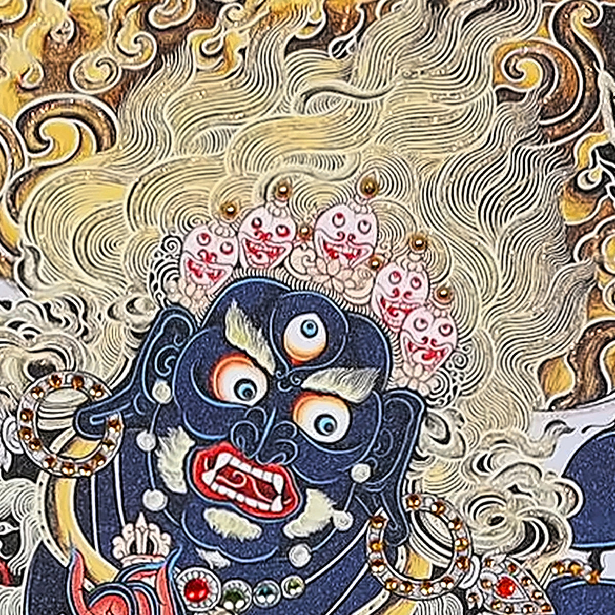 Six-Armed Mahakala thangka detail: three-eyed dark blue face under a crown of five skulls