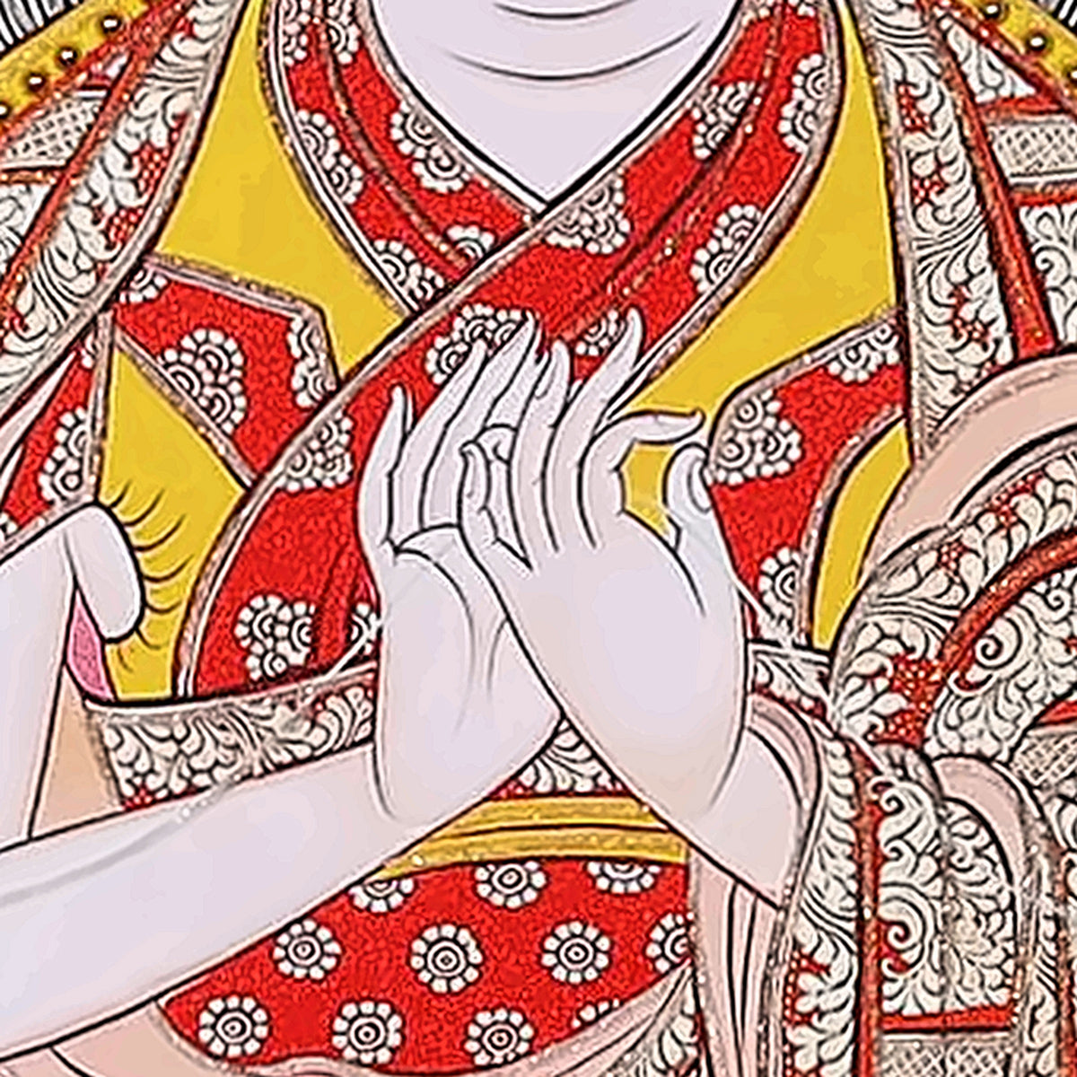 Tsongkhapa thangka detail: hands at the heart in the teaching gesture, red and gold robes