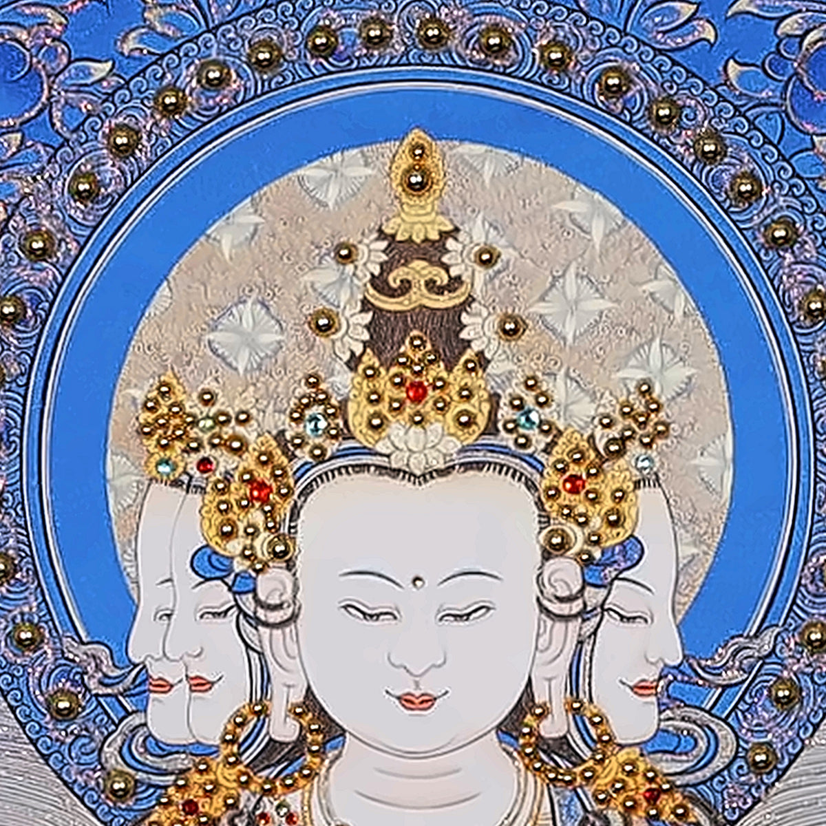 Vairocana thangka detail: white faces under a jewelled crown