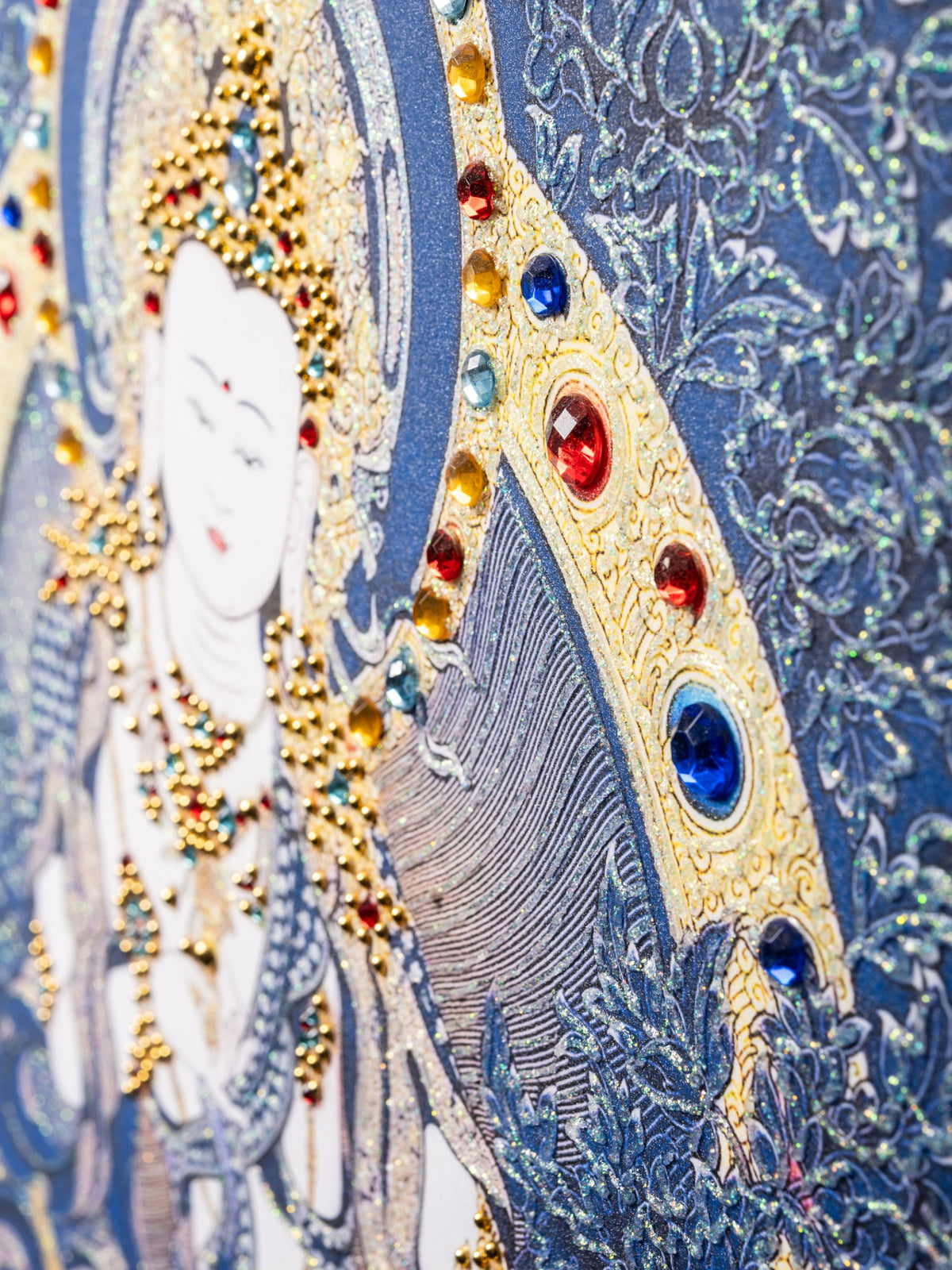 Vajrasattva thangka detail at an angle: crystals and glitter outlines catching the light