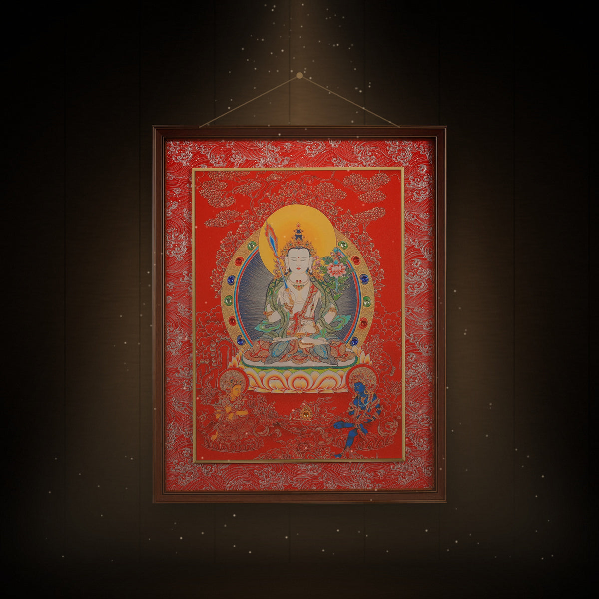 White Manjushri thangka hanging in a room under warm light