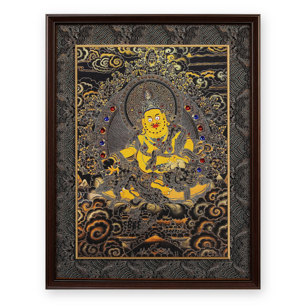 Yellow Jambhala black and gold thangka, framed in Ink & Gold silk brocade, on a white background