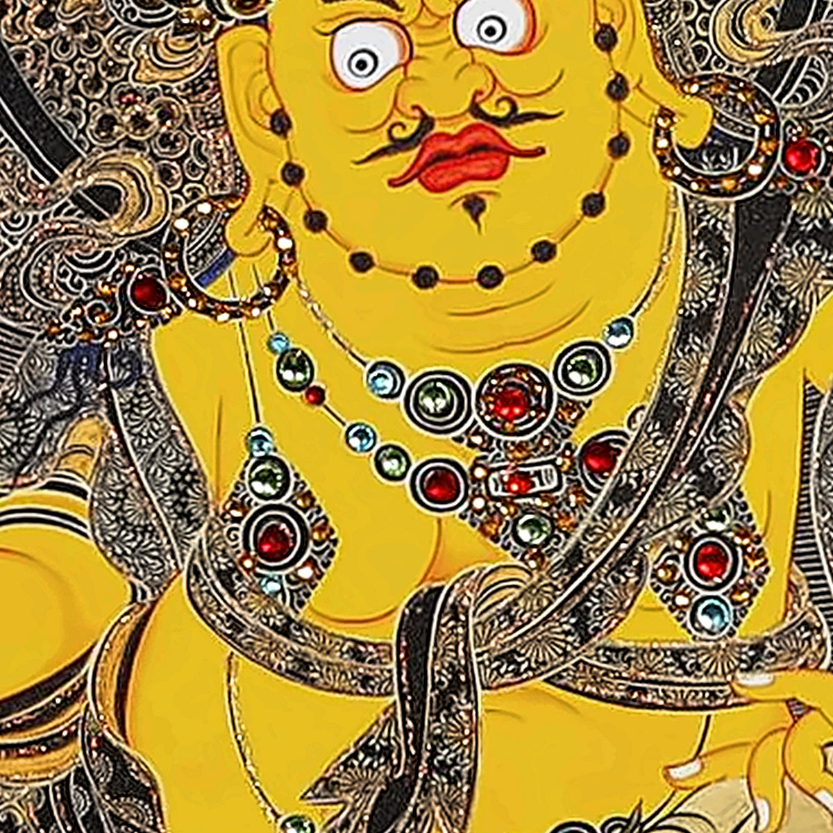 Yellow Jambhala thangka detail: jewelled necklaces set with red, green and clear crystals